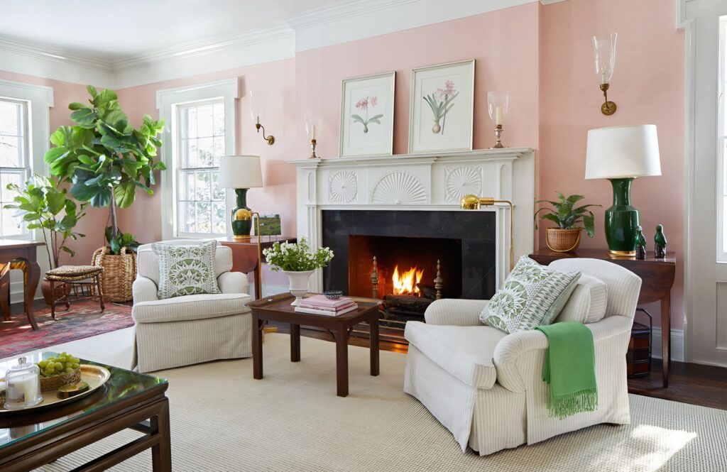 Living room with soft pink paint and crisp white trim by an interior painter in Ashland, MA