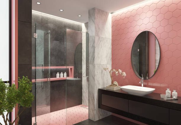 Bathroom with pink paint, dark gray walls, and white marble finishes by an interior painter in Milton, MA.