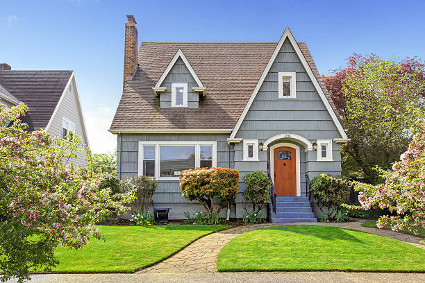 Gray home exterior with white trim and contrasting finishes by an exterior painter in Natick, MA.